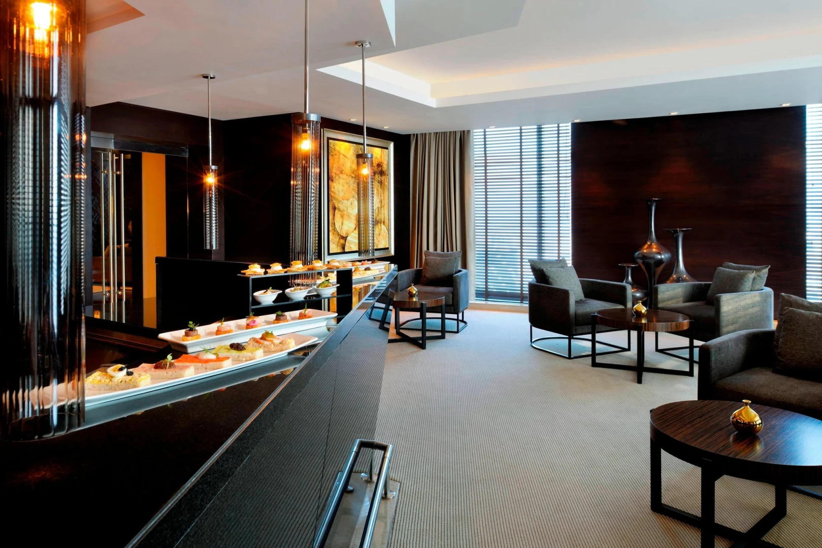 Elegant lounge at JW Marriott Marquis Hotel Dubai with seating and decor.