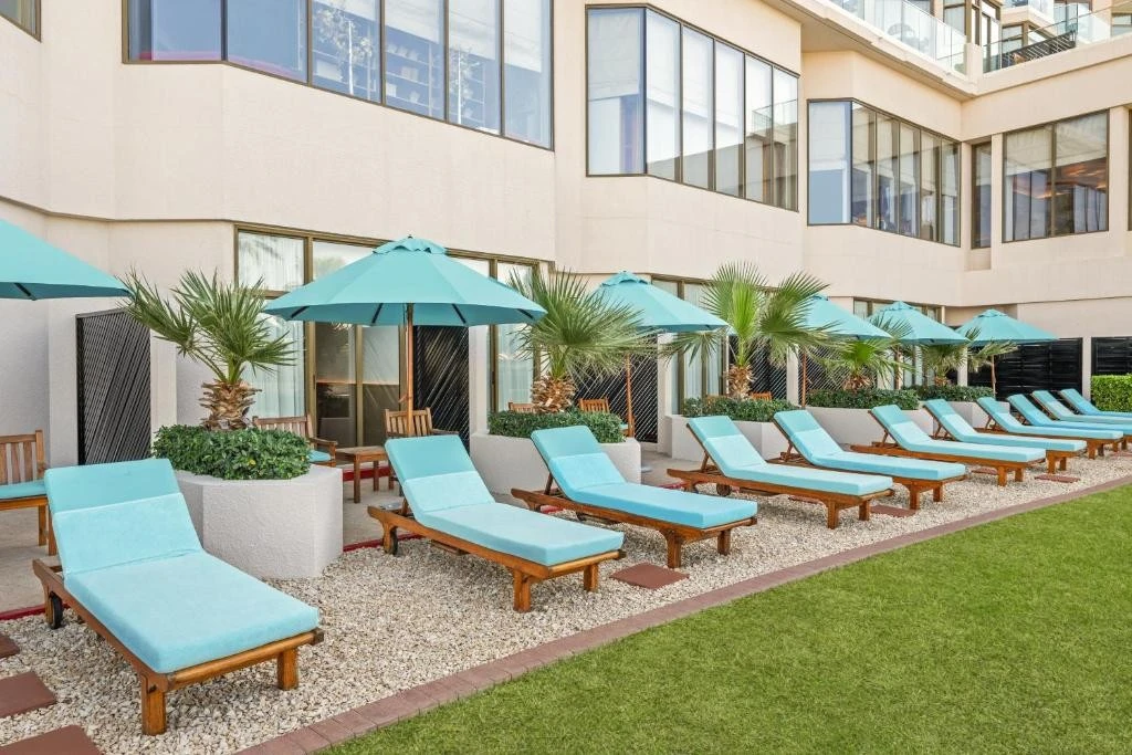 Poolside loungers and umbrellas at JA Beach Hotel, Dubai.