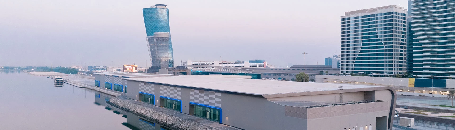 ADNEC Centre Abu Dhabi exterior with modern architecture and waterfront view.