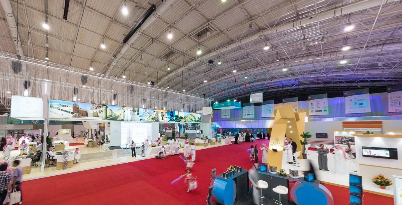 Riyadh International Convention bustling with attendees and colorful displays.